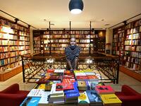 An Iranian employee poses for a picture at a bookstore in Tehran's Enqelab (Revolution) street, on September 8, 2020. ATTA KENARE / AFP