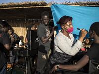 Fashion models get their make-up and hair done ahead of the start of Dakar Fashion Week in Dakar on December 12, 2020. JOHN WESSELS / AFP