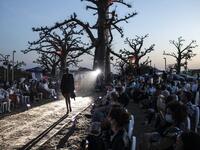A fashion model walks down the runway during Dakar Fashion Week in Dakar on December 12, 2020. JOHN WESSELS / AFP