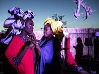 A fashion model gets the final touches done to her outfit during Dakar Fashion Week in Dakar on December 12, 2020. JOHN WESSELS / AFP