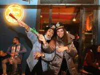 People share a drink to celebrate New Year's eve at a pub in the capital Beirut on January 1, 2021. ANWAR AMRO / AFP
