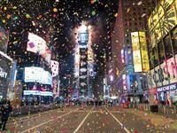 Confetti are flying in the air on a mostly empty Times Square for New Year’s Eve in New York City on January 1, 2021. Due to the Coronavirus outbreak Times Square is closed to all but a few revelers. COREY SIPKIN / AFP