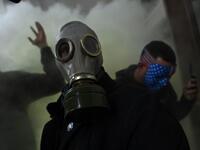 A supporter of US President Donald Trump wears a gas mask as he protests after storming the US Capitol on January 6, 2021, in Washington, DC. Demonstrators breeched security and entered the Capitol as Congress debated the a 2020 presidential election Electoral Vote Certification. President-elect Joe Biden denounced the storming of the US Capitol as an "insurrection" and demanded President Donald Trump go on television to call an end to the violent "siege." Brendan SMIALOWSKI / AFP