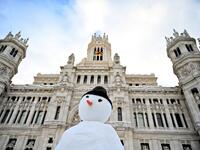 A snowman is built outside the Cibeles Palace in Madrid on January 10, 2021. Snowstorms in Spain left three people dead and caused chaos across much of the country, trapping motorists and shutting down the capital's air and rail links. Gabriel BOUYS / AFP