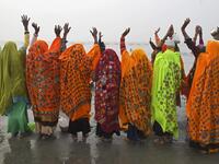 Hindu pilgrims pray after taking a holy dip at the confluence of Ganges and the Bay of Bengal during the Gangasagar Mela on the occasion of Makar Sankranti, a day considered to be of great religious significance in Hindu mythology, at Sagar Island, around 150 kms south of Kolkata on January 14, 2021. Dibyangshu SARKAR / AFP