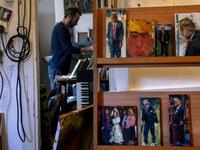 Israeli painter Iddo Markus works at his studio where he displays some of his paintings of former US president Donald Trump, in the northern port city of Haifa, on January 22, 2021. Markus became fascinated by the "tragic figure" of Donald Trump, and the walls and floor of his studio are packed with some 120 portraits of the former US presidents. Emmanuel DUNAND / AFP