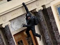 A protester supporting U.S. President Donald Trump jumps from the public gallery to the floor of the Senate chamber at the U.S. Capitol Building on January 06, 2021 in Washington, DC. Congress held a joint session today to ratify President-elect Joe Biden's 306-232 Electoral College win over President Donald Trump. A group of Republican senators said they would reject the Electoral College votes of several states unless Congress appointed a commission to audit the election results Win McNamee/Getty Images/A
