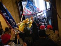 A pro-Trump mob breaks into the U.S. Capitol on January 06, 2021 in Washington, DC. Congress held a joint session today to ratify President-elect Joe Biden's 306-232 Electoral College win over President Donald Trump. A group of Republican senators said they would reject the Electoral College votes of several states unless Congress appointed a commission to audit the election results. Win McNamee/Getty Images/AFP