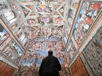 A man visits the Sistine Chapel on the reopening day of the Vatican museum on February 1, 2021 in Vatican City, as the city-state eases its closure aimed at curbing the spread of the COVID-19 infection, caused by the new coronavirus. Andreas SOLARO / AFP