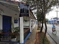 A man passes by a closed handicraft shop in Vinales, Cuba, on January 28, 2021. At the foot of the majestic rock formations of Vinales, the terraces of the restaurants look empty and the lodgings have closed. With the arrival of COVID-19, the incipient prosperity of this Cuban town came to a halt and people abandoned tourism jobs to return to work the land. YAMIL LAGE / AFP