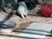 A worker employed by a pilot project run by the UN cultural agency UNESCO, restores a mosaic floor at an ancient church complex, in the small town of Rihab, some 70 kilometres north of the Jordanian capital Amman, on February 9, 2021. In the ruins of the ancient Byzantine church in Jordan, local townspeople and Syrian refugees work side by side on a project that unites preserving cultural heritage and fighting poverty.  Khalil MAZRAAWI / afp