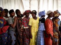 A group of gold miners queue in the backstage after having been selected by the Princess of Burundi, Esther Kamatari, to take part in a fashion show as part of the first edition of the International Gold Fair Afrik'Or, in Bamako, on February 12, 2021. The Princess of Burundi, selected 34 women among gold mines workers in southern Mali, to walk down the catwalk for a fashion show organised during the International Gold Fair. Gold represents 15% of Mali's exports and more than 20% of its GDP estimated at near