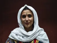 A Syrian Kurdish woman in traditional attire 