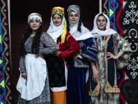 Syrian Kurdish women in traditional attire pose 