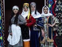 Syrian Kurdish women in traditional attire pose 