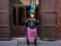 A carnival participant dressed in costume and wearing body paint 