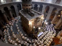 Christian worshippers, monks, and friars walk in procession around the Edicule, traditionally believed to be the burial site of Jesus Christ