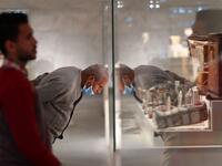 People look at displayed artifacts at Egypt's new National Museum of Egyptian Civilisation (NMEC)