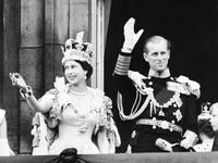  June 2, 1953 Britain's Queen Elizabeth II (L) accompanied by Britain's Prince Philip, Duke of Edinburgh (R) waves to the crowd, June 2, 1953 
