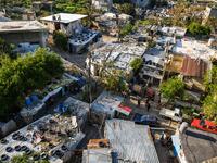 This picture  shows an elevated view of shacks where multiple marginalised families reside in the Ghoraba (Strangers) cemetery