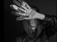 A musician in foil gloves is playing an instrument