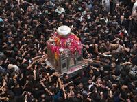 Shiite Muslim devotees take part in a procession to commemorate the death anniversary of Prophet Mohammad's companion 