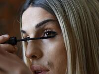 Albanian transgender Denisa, puts her makeup on, in the former Communist-era maximum security prison for political prisoners in Spac