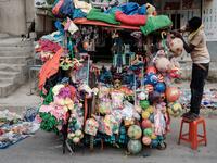 A man prepares to sell toys to Ethiopian Orthodox devotees before the start of the Saint Michael's anniversary celebration near St. Michael church in Mekele, the capital of Tigray region, Ethiopia
