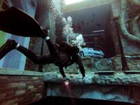 A diver explores a mock sunken city as he experiences Deep Dive Dubai, the deepest swimming pool in the world reaching 60m, in the United Arab Emirates, on July 10, 2021. The city of superlatives, with the world's tallest tower among its many records, Dubai now has the deepest swimming pool on the planet complete with a "sunken city" for divers to explore. GIUSEPPE CACACE / AFP