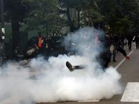 A demonstrator kicks back a tear gas canister during clashes following a protest against the inauguration of the new head of the Serbian Orthodox Church on September 5, 2021 in the historic city of Cetinje in Montenegro.  