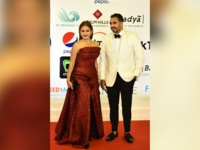 Egyptian actress Nelly Karim (L) and her husband pose on the red carpet during the opening of the 43rd edition of the Cairo International Film Festival (CIFF) at the Cairo Opera House in the Egyptian capital on November 26, 2021. (Photo by Sayed HASAN / AFP)