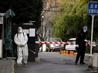 A worker in Chinese residential area under lockdown
