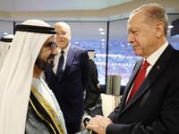 Erdogan and This handout photograph taken and released by The Press Office of the Presidency of Turkey on November 20, 2022, shows Turkish President Recep Tayyip Erdogan (R) shakes hands with Sheikh Mohammed bin Rashid al-Maktoum 