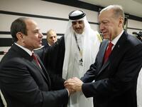 3) This handout photograph taken and released by The Press Office of the Presidency of Turkey on November 20, 2022, shows Turkish President Recep Tayyip Erdogan (R) shakes hands with Egyptian President Abdel Fattah el-Sisi as they are welcomed by Qatari Emir Sheikh Tamim bin Hamad al-Thani (2ndR) 