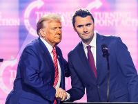US right-wing activist Charlie Kirk (R) speaks on stage with President Donald Trump