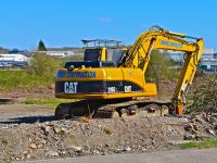 Bridgend. County Borough of Bridgend / Wales UK - 3/24/2019: New building site on the outskirts of Bridgend. A Caterpillar 315CL hydraulic excavator.