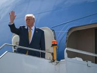 U.S. President Donald Trump waves as he departs on Air Force One from Kuala Lumpur International Airport in Sepang on October 27, 2025. Photo by ANDREW CABALLERO-REYNOLDS / AFP U.S. President Donald Trump
