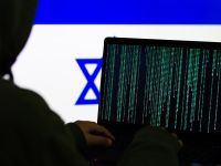 Computer Hacker in front of flag