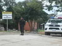 Policeman standing guard outside the hospital where Beller lies.