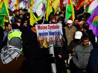 Protesters hold flags and posters reading "My symbols - my identity" during a demonstration of Kurdish groups to protest against Turkey's offensive against Kurds in Syria's Afrin region, on Mar. 3, 2018 in Berlin. 
(John MACDOUGALL / AFP)
