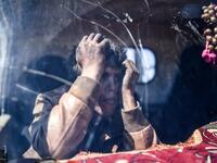 A young boy waits at a check point in the village of Anab ahead of crossing to the Turkish-backed Syrian rebels side on Mar. 17, 2018, as civilians flee the city of Afrin in northern Syria. (BULENT KILIC / AFP)