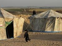 A girl runs next to tents pitched by Palestinians on the Gaza border with Israel (background), east of Jabalia, on Mar. 29, 2018, ahead of a six-week protest camp. The exceptional protest is dubbed "The Great March of Return" and has the backing of the Gaza Strip's Islamist rulers Hamas.
MAHMUD HAMS / AFP