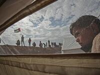 A Palestinian child stands outside a tent during a a tent city protest near Khan Yunis in the southern Gaza Strip on Mar. 30, 2018. Land Day marks the killing of six Arab Israelis during 1976 demonstrations against Israeli confiscations of Arab land.
(SAID KHATIB / AFP)