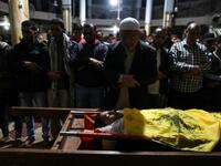 Relatives of 15-year-old Palestinian Mohammed Ibrahim Ayoub, who was shot and killed by Israeli security forces during clashes along the Israel-Gaza border, pray over his body during his funeral in Beit Lahia in the northern Gaza strip on April 20, 2018. (STRINGER / AFP)