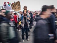 Pierre Gilbert, a 37 year old sociology university teacher, poses with his daughter during the annual May Day workers' rally in Paris on May 1, 2018 / AFP