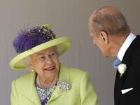 Britain's Queen Elizabeth II (L) talks with Britain's Prince Philip, Duke of Edinburgh (R) as they leave after attending the wedding ceremony of Britain's Prince Harry, Duke of Sussex and US actress Meghan Markle at St George's Chapel, Windsor Castle, in Windsor, on May 19, 2018. 
Alastair Grant / AFP