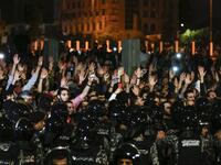 Jordanian protesters raise their hands in before members of the gendarmerie and security forces during a demonstration outside the Prime Minister's office in the capital Amman late on June 2, 2018.
Khalil MAZRAAWI / AFP