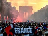 People celebrate France's victory in the Russia 2018 World Cup final football match between France and Croatia, on the Champs-Elysees avenue in Paris on July 15, 2018. 
Eric FEFERBERG / AFP
