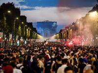 People celebrate France's victory in the Russia 2018 World Cup final football match between France and Croatia, on the Champs-Elysees avenue in Paris on July 15, 2018. 
Eric FEFERBERG / AFP