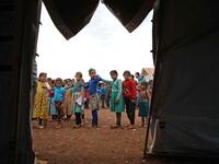 Syrian children who fled with their families from the northern countryside of Hama, line up in the yard of the makeshift school of "Zuhur al-Mustaqbal" (in Arabic "Flowers of the Future") in al-Jeneinah camp for displaced people in the village of Atme, in Syria's mostly rebel-held northern Idlib province, on October 1, 2018. Aaref WATAD / AFP
